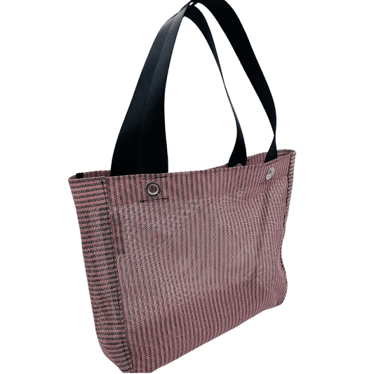 Pink reusable grocery bag against a white background.